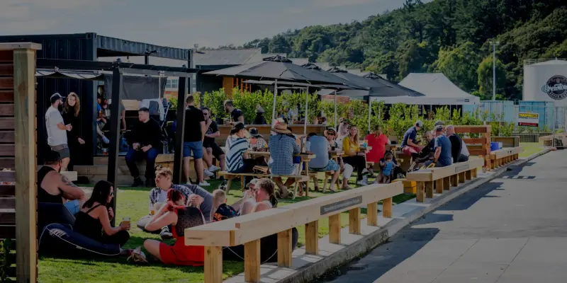People relaxing at outdoor tables in the Brewtown courtyard, Upper Hutt